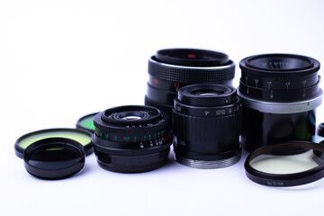 set of old-vintage lenses and color photo filters on a white background