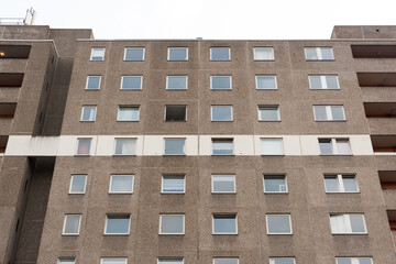 Cheap apartment in a gray high-rise building with a white stripe 