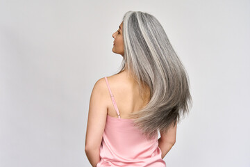Back view of senior mature middle aged older Asian lady with long gray natural coloring vibrant...