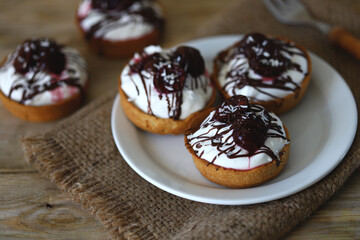 Delicious tartlets with cream cheese, chocolate and cherries. Healthy dessert with curd cheese. Mascarpone dessert. Keto dessert.