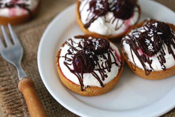Delicious tartlets with cream cheese, chocolate and cherries. Healthy dessert with curd cheese. Mascarpone dessert. Keto dessert.