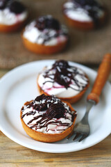 Delicious tartlets with cream cheese, chocolate and cherries. Healthy dessert with curd cheese. Mascarpone dessert. Keto dessert.