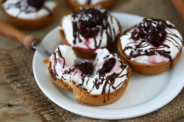Delicious tartlets with cream cheese, chocolate and cherries. Healthy dessert with curd cheese. Mascarpone dessert. Keto dessert.
