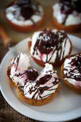 Delicious tartlets with cream cheese, chocolate and cherries. Healthy dessert with curd cheese. Mascarpone dessert. Keto dessert.