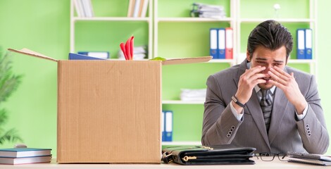 Male employee collecting his stuff after redundancy