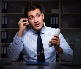 Call center operator talking to customer during night shift
