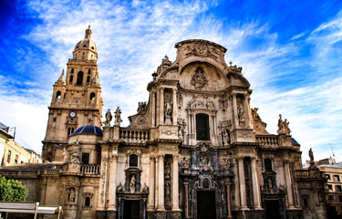 Fototapeta na wymiar Tower bell, sculptures and carved stone details of the Cathedral of Murcia