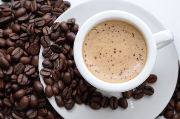 Coffee in a cup, aromatic coffee beans isolated on white.