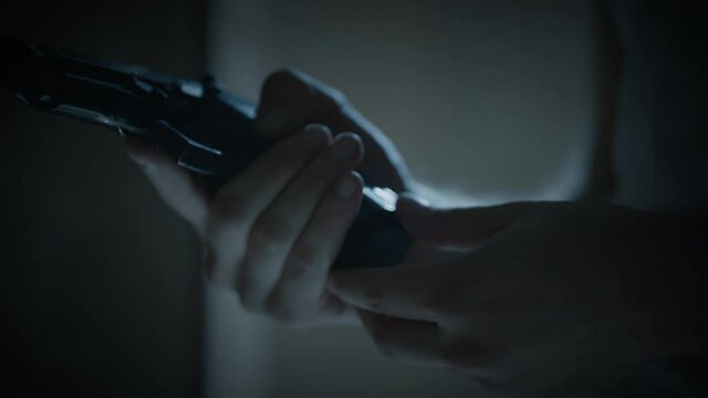 young man raises the gun and pulls the trigger