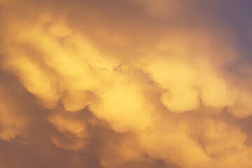 Dramatic stormy clouds on the sky with sunset light . Spring special background.