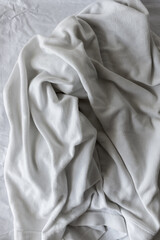 grey-white cotton fabric - photographed from above with low or raking light - emphasis on texture and folds