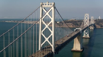 Cinematic Aerial footage of the San Francisco Oakland Bay Bridge on a beautiful afternoon - California USA