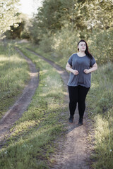 Overweight woman jogging outdoors at the open air