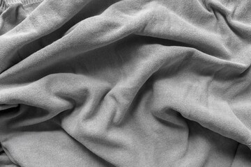 grey cotton fabric - photographed from above with low or raking light - emphasis on texture and...