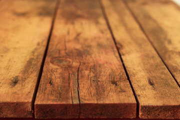 Old wooden table close up. Weathered yellow background.