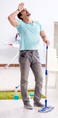 Young attractive man husband doing mopping at home