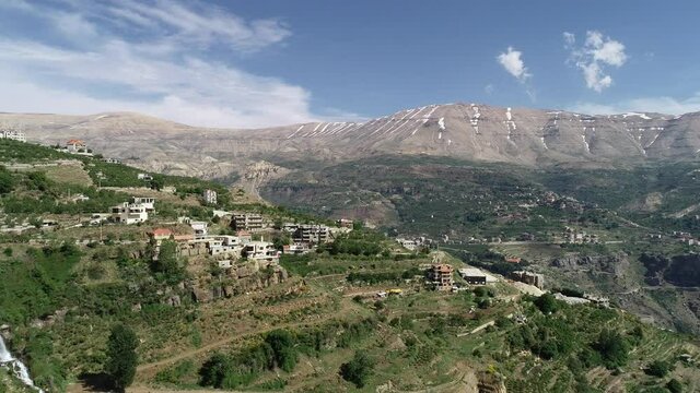 Beautiful village near the valley. Aerial footage of the city and valley. Best hiking trails. Middle East region. Summer vacation in Lebanon. Mountains with snow melting