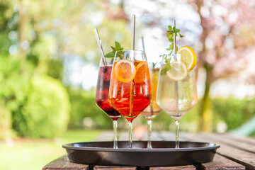 Close-up of delicious alcoholic summer cocktails on a wooden table in the summer outdoors