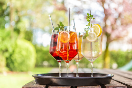 Close-up of delicious alcoholic summer cocktails on a wooden table in the summer outdoors