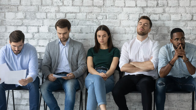Tired job candidates waiting for interview far too long. Unemployed applicant sitting on chairs in queue, reading resume, preparing for appointment with employer or HR manager, getting worry, sleeping