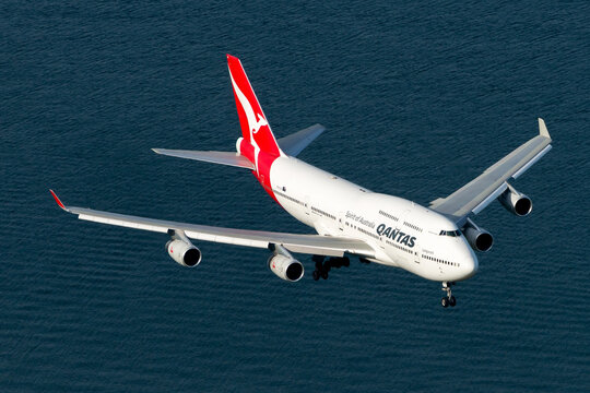 Qantas Airways Boeing 747 aircraft over Botany Bay waters. Long range B747 plane on final approach to Sydney Kingsford Smith International Airport. Airplane VH-OJS.