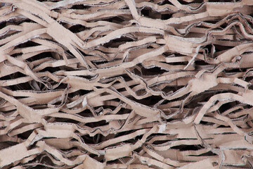 Shredded and crimped brown cardboard background texture