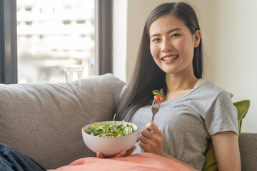 eat healthy food on wellness lifestyle. Beauty young woman eating salad as a breakfast.
