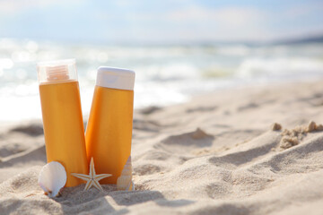 Sunscreens on the beach near the sea close up