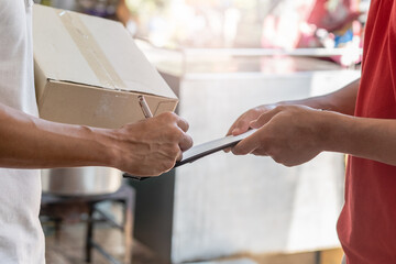 Delivery Man sending package to receiver on doorway.