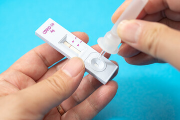 Hands of men who use COVID-19 home antigen kits to test for coronavirus.