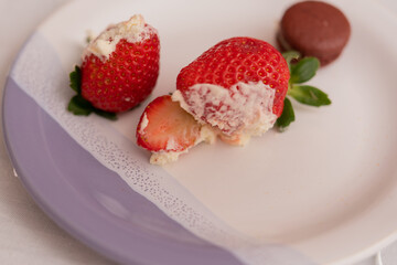 Delicious strawberries and cream on a plate.