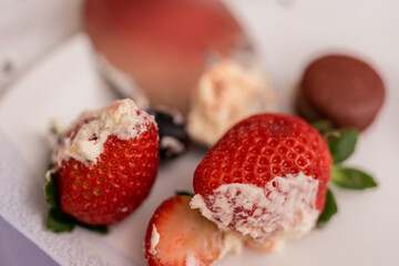 Delicious strawberries and cream on a plate.