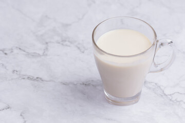 Soy milk and Soybeans on wooden table background. Healthy food Concept.