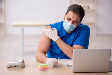 Young male doctor in vaccination concept