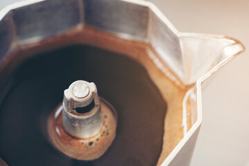 Close up coffee brewing in Italian espresso maker moka pot
