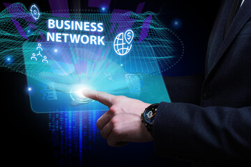 Business, Technology, Internet and network concept. Young businessman working on a virtual screen of the future and sees the inscription: Business network