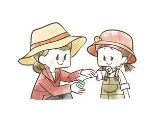 女の子の腕に日焼け止めを塗る女性