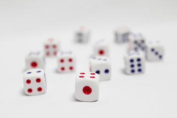 selective focus of spread of dice on white background. high key photography.