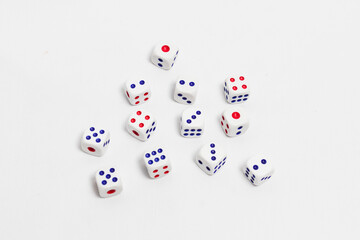 spread of dice on white background. high key photography.