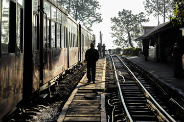 a man is walking at kalka shimla railway track in himachal pradesh.