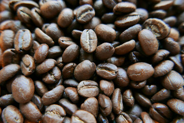 Dark coffee beans close-up, texture background