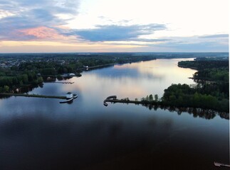 Aerial view sunset on the river. Colorful clouds are reflected in the water. Beautiful panorama of nature at sunset.