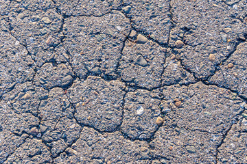 texture of cracked old road surface, background of old broken asphalt road or sidewalk