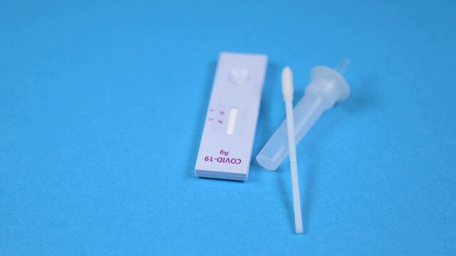Covid-19 Ag home self-test kit on a blue background.