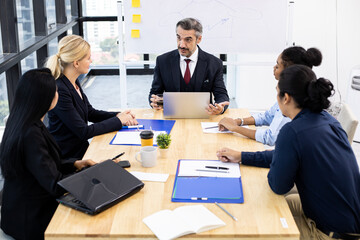 Business team and manager in meeting room.