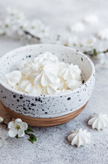 Small white meringues in the  ceramic bowl