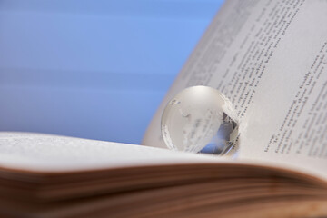 glass globe on an open book