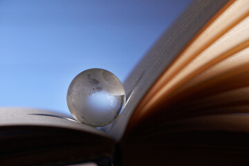glass globe on an open book