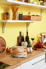 Fototapeta na wymiar Cooking utensils and products on table in modern kitchen
