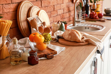 Cooking utensils and products on table in modern kitchen